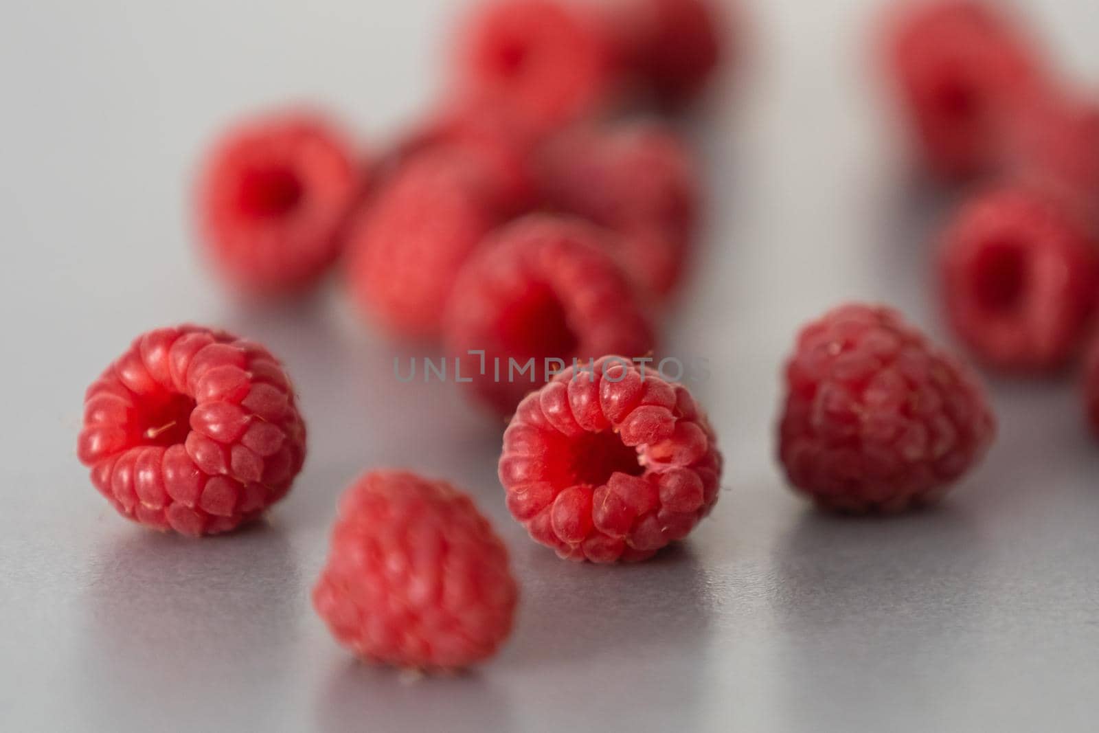 red Raspberry fruit on gray background chocolate