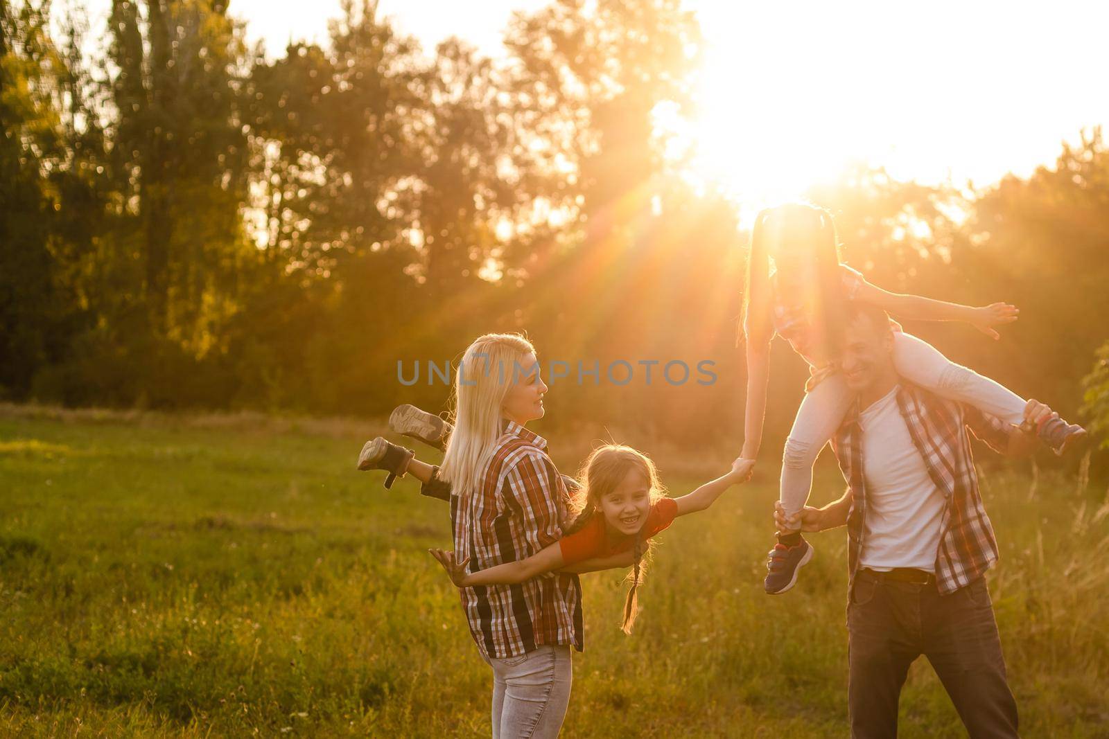 Happy family on sunset in nature by Andelov13