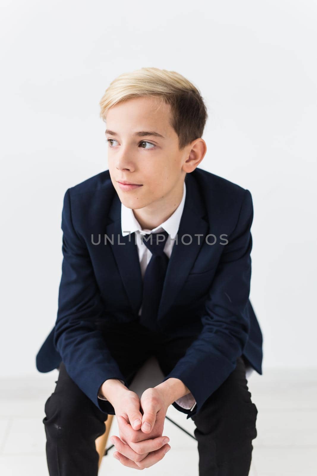 Portrait of stylish school boy teenager in white shirt and jacket against white background. by Satura86