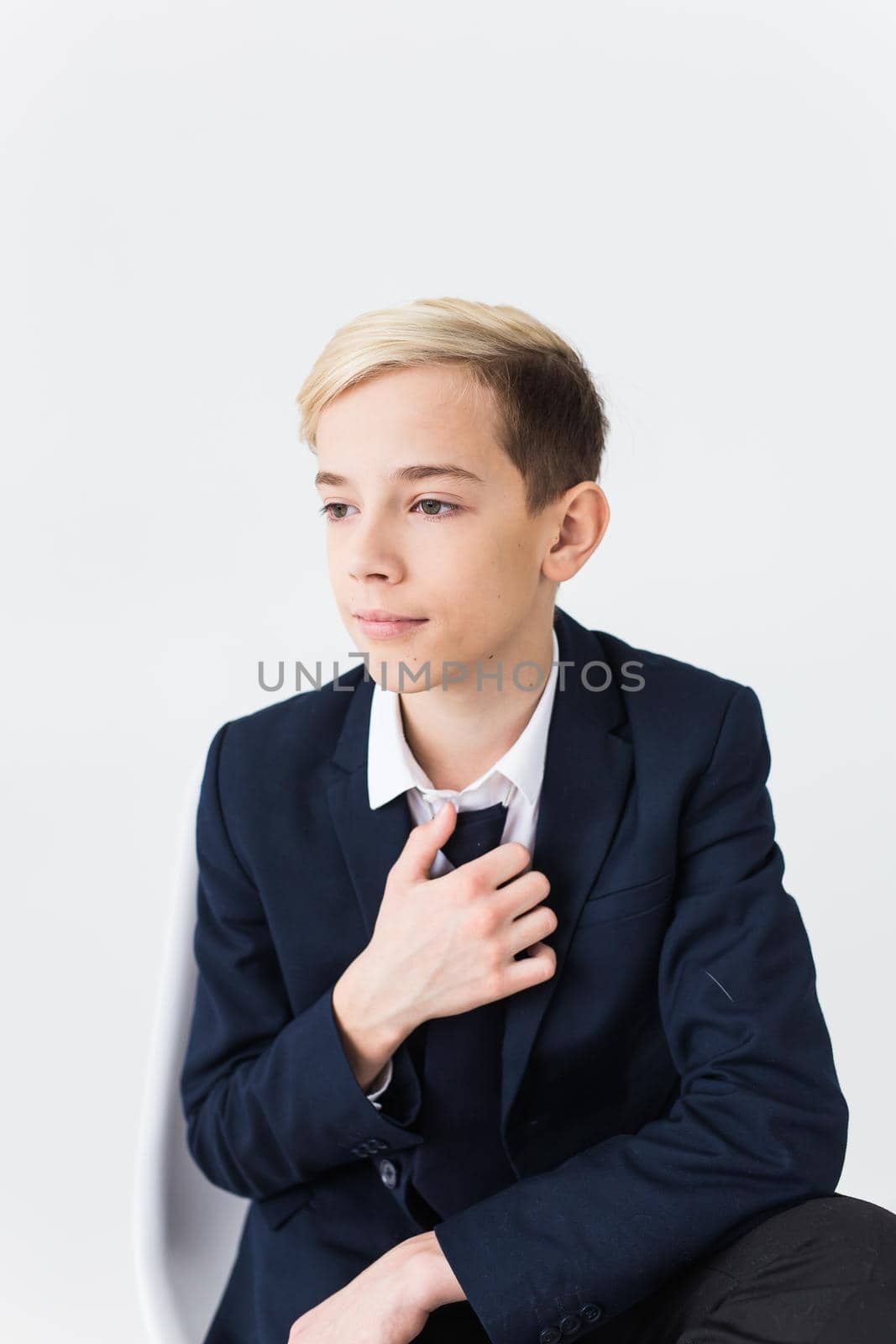 Portrait of stylish school boy teenager in white shirt and jacket against white background. by Satura86