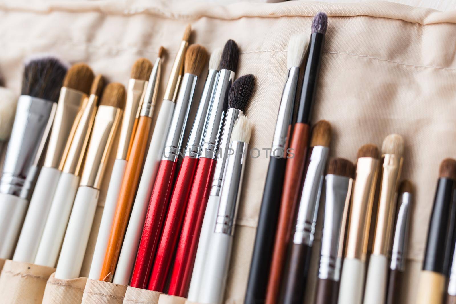 Makeup, beauty and cosmetics concept - Set of make-up brushes in a light case. by Satura86