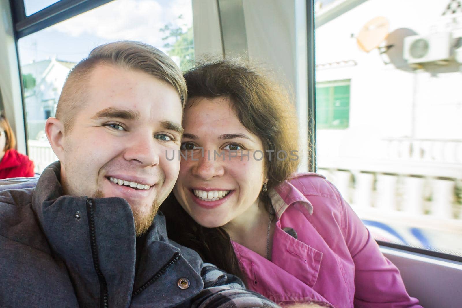 Young couple on vacation in Europe on the train take photo selfie