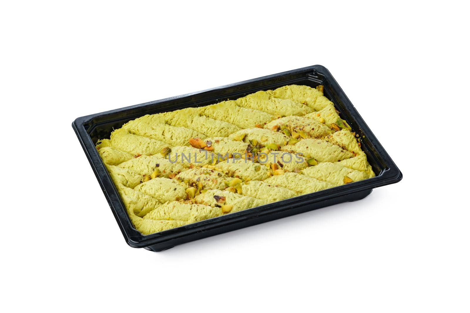 Black plastic box of Turkish halva dessert isolated on white background