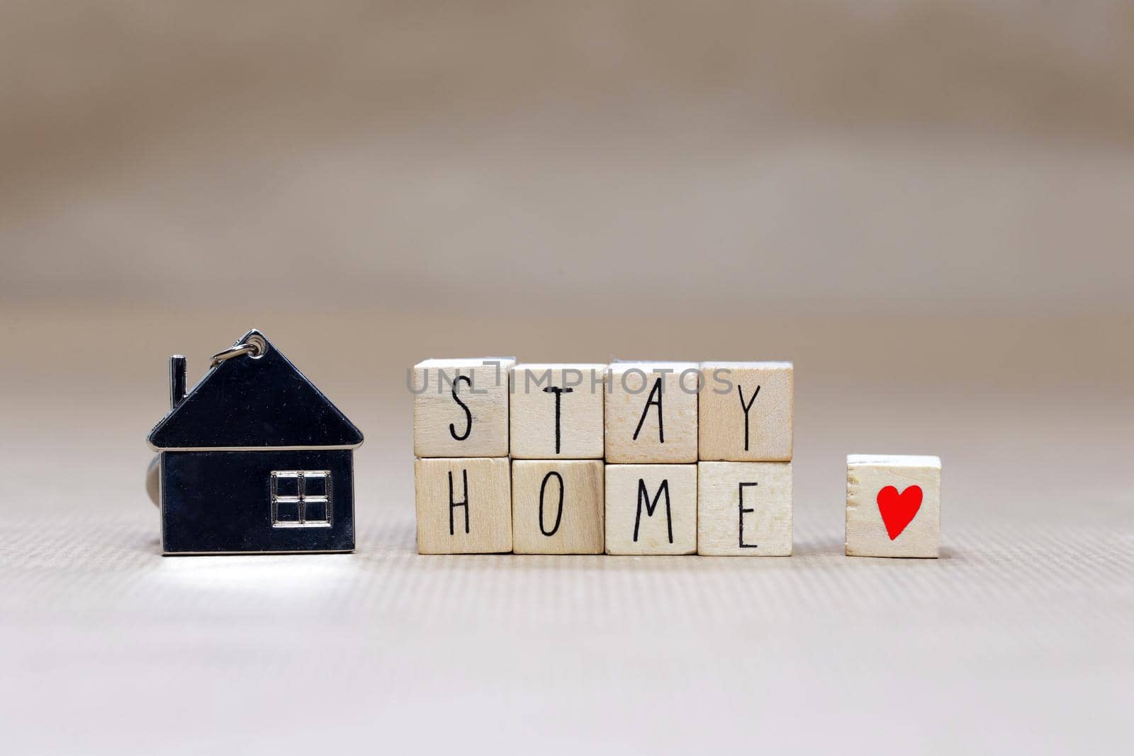 Stay home written with wooden cubes and miniature house, Covid-19, health stay at home. Quarantine concept. background copy space text
