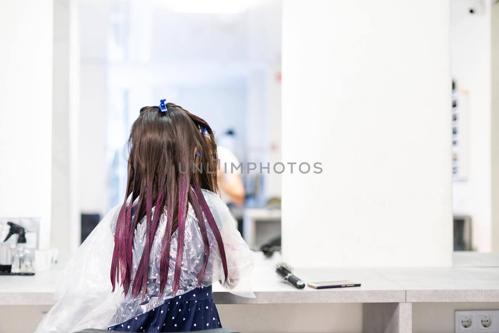 hairdresser dyes hair for a little girl in a hair salon. Dyed, bleached hair by Andelov13