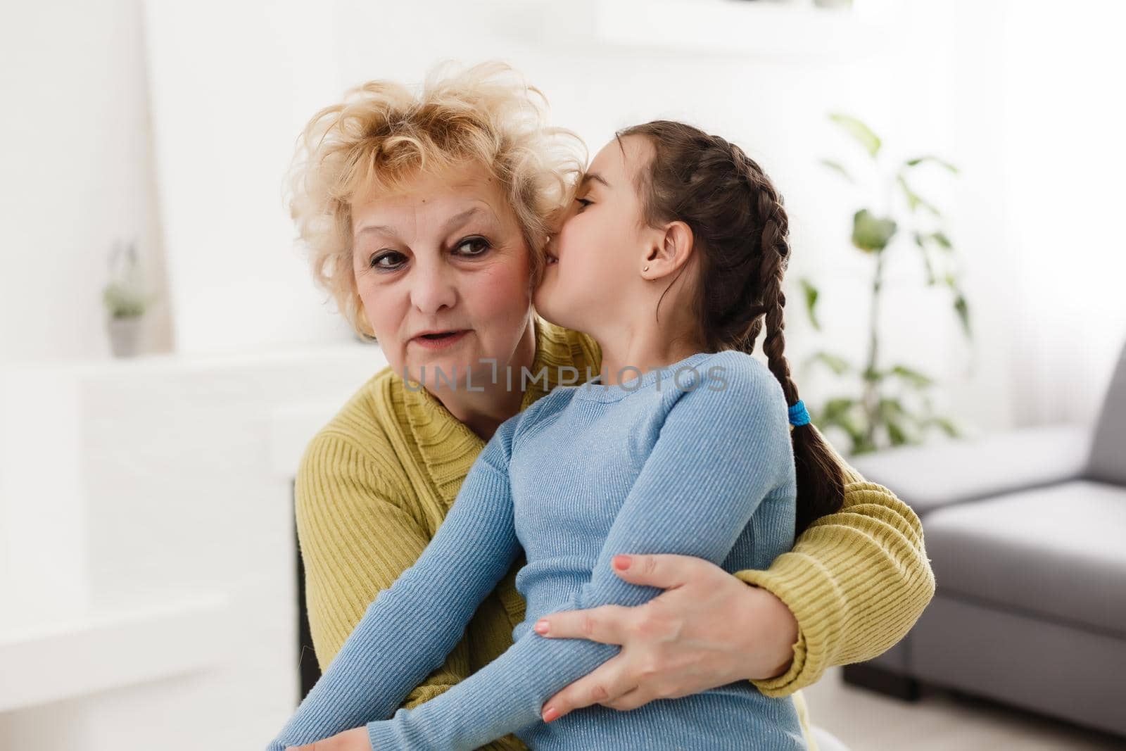 Grandmother and granddaughter portrait, embraced by Andelov13