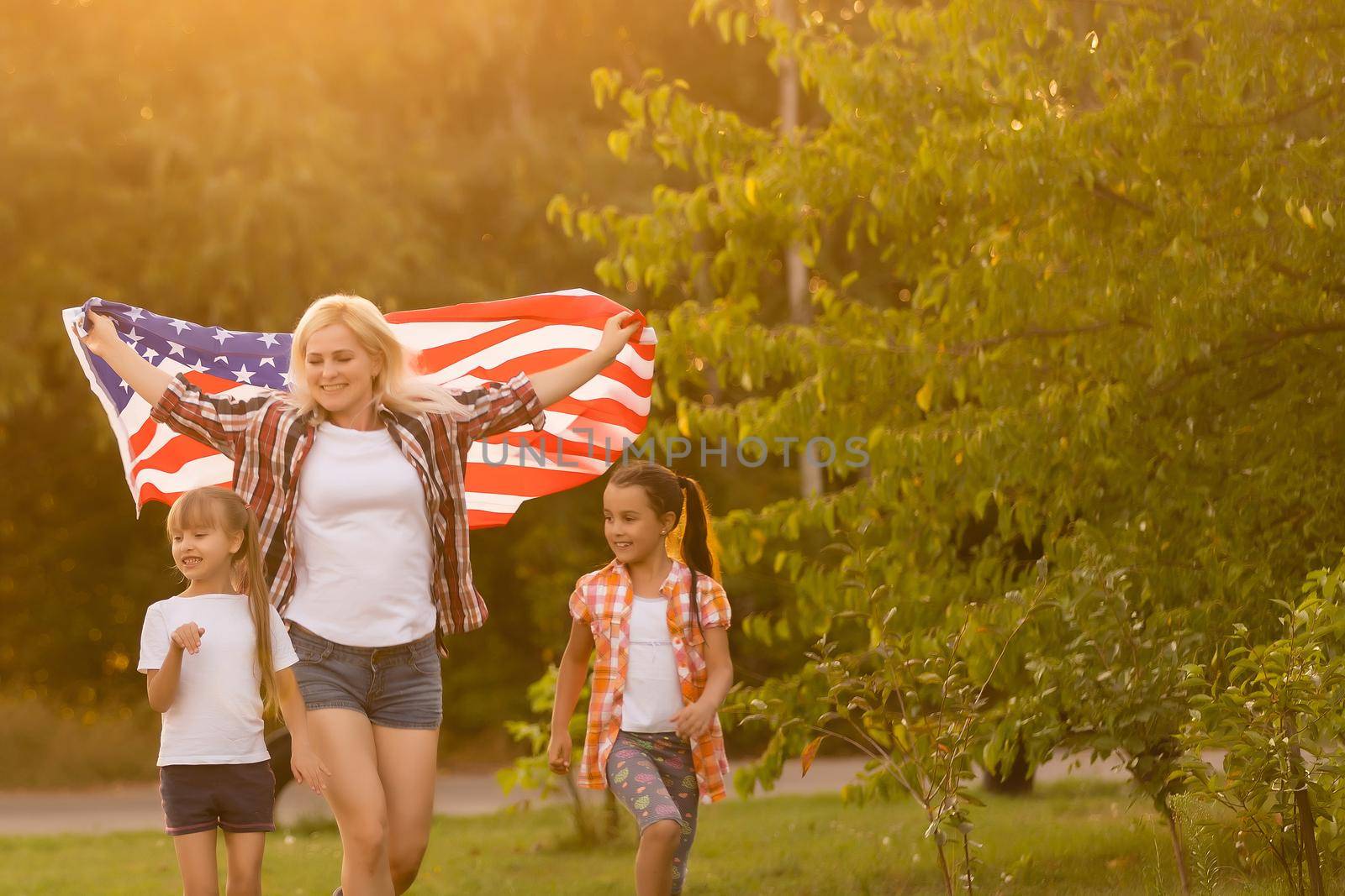 Family Posing Outdoors With American Flag