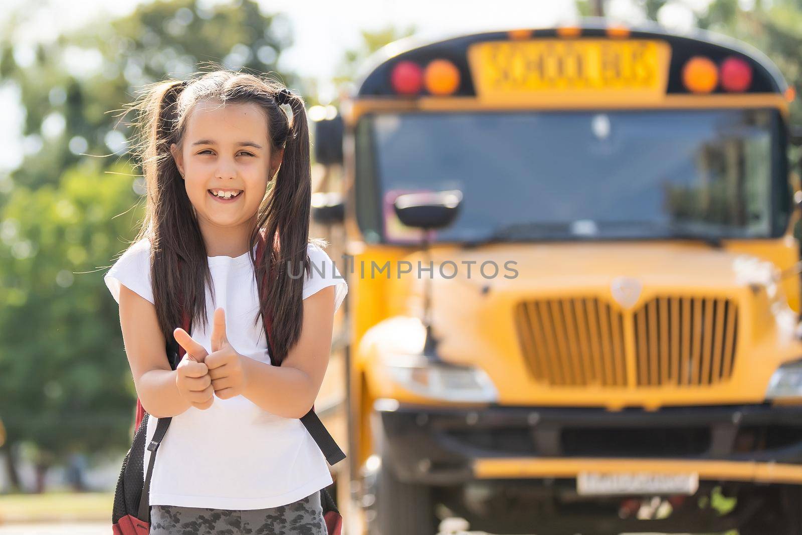 Mother brings her daughter to school near the school bus. back to school by Andelov13