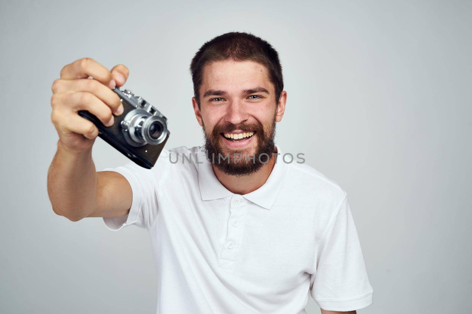 man holding camera professional photographer home light background. High quality photo