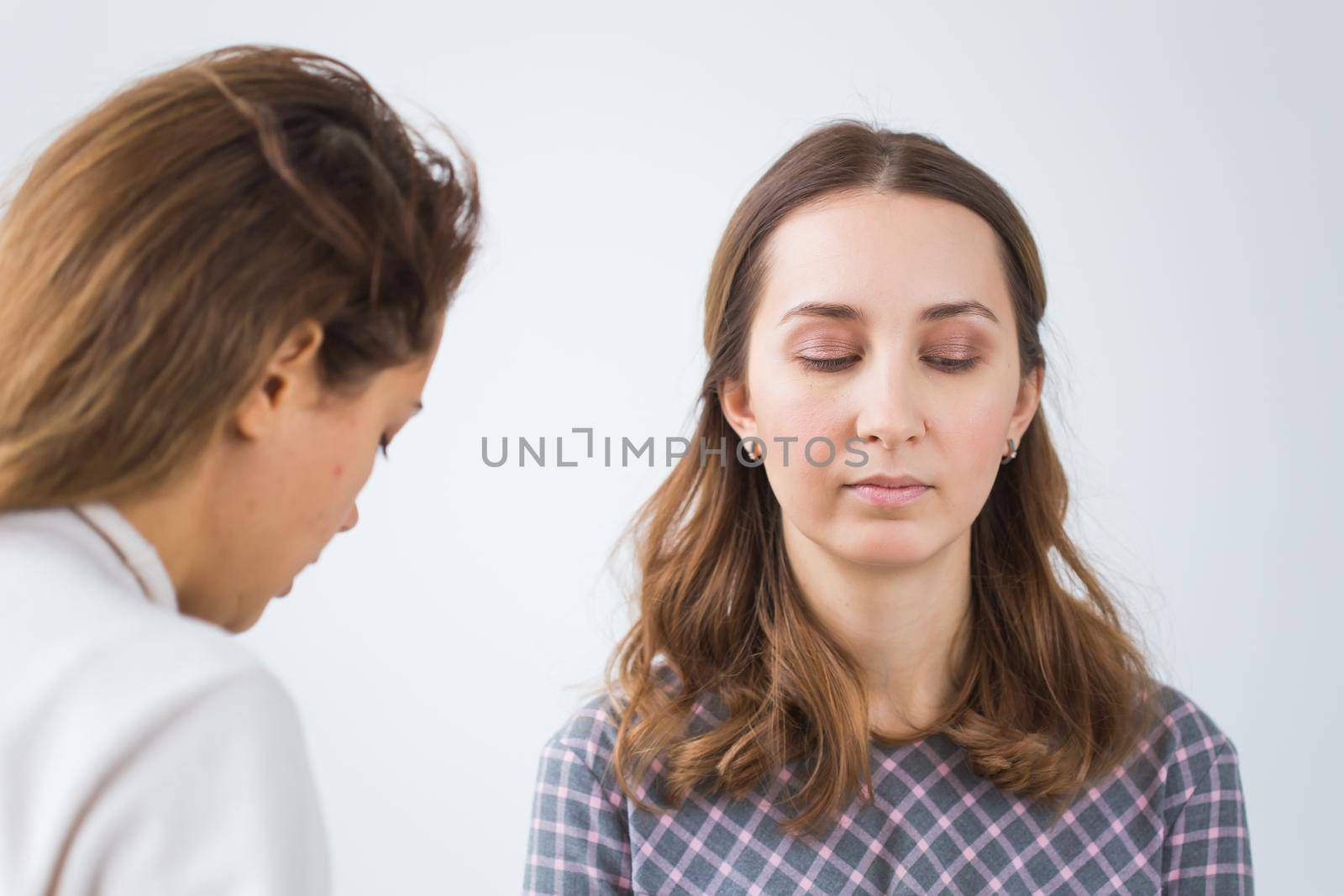 Beauty and cosmetics concept - Makeup artist doing professional make up of young woman by Satura86