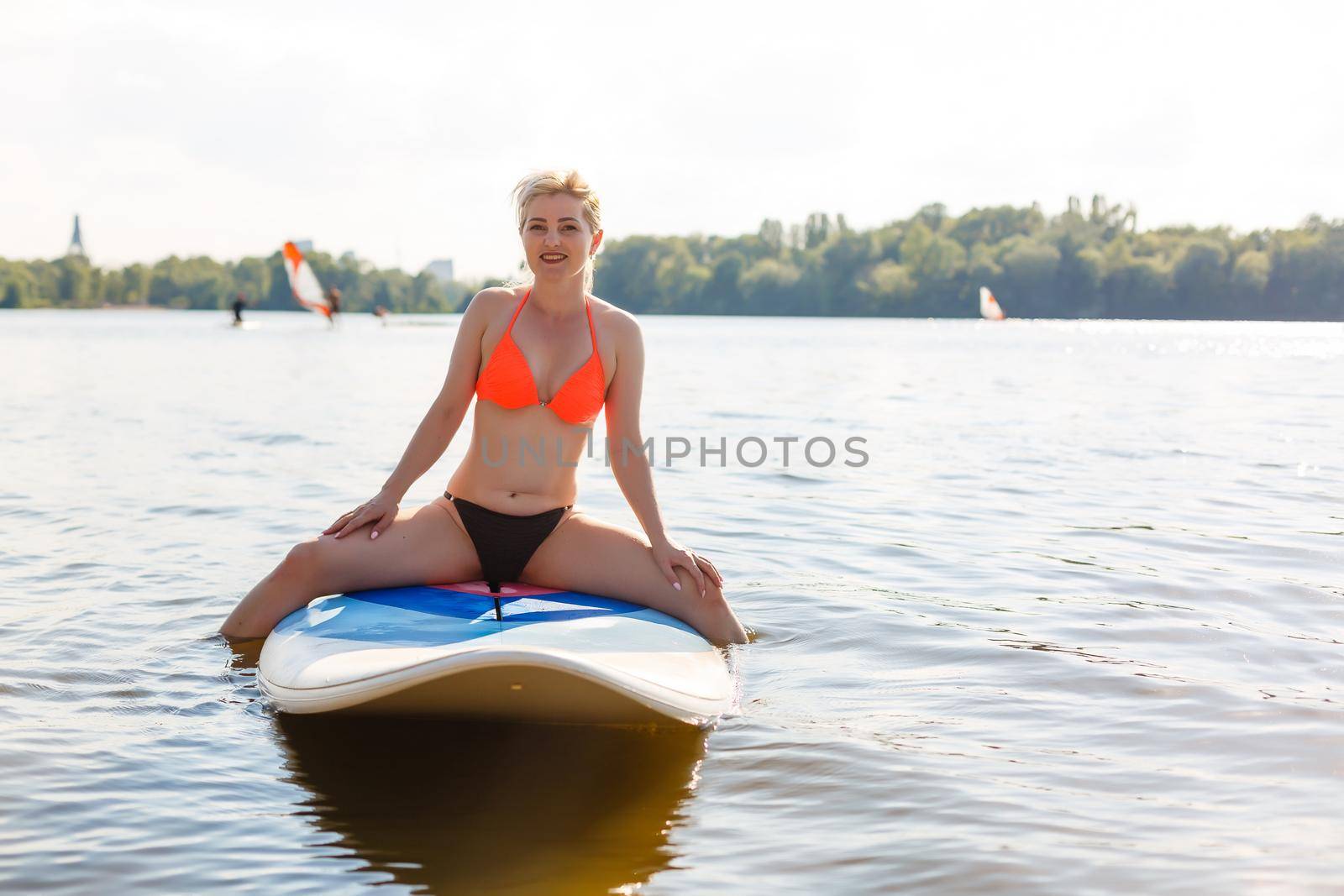 A beautiful woman practicing paddle on a beautiful sunny day