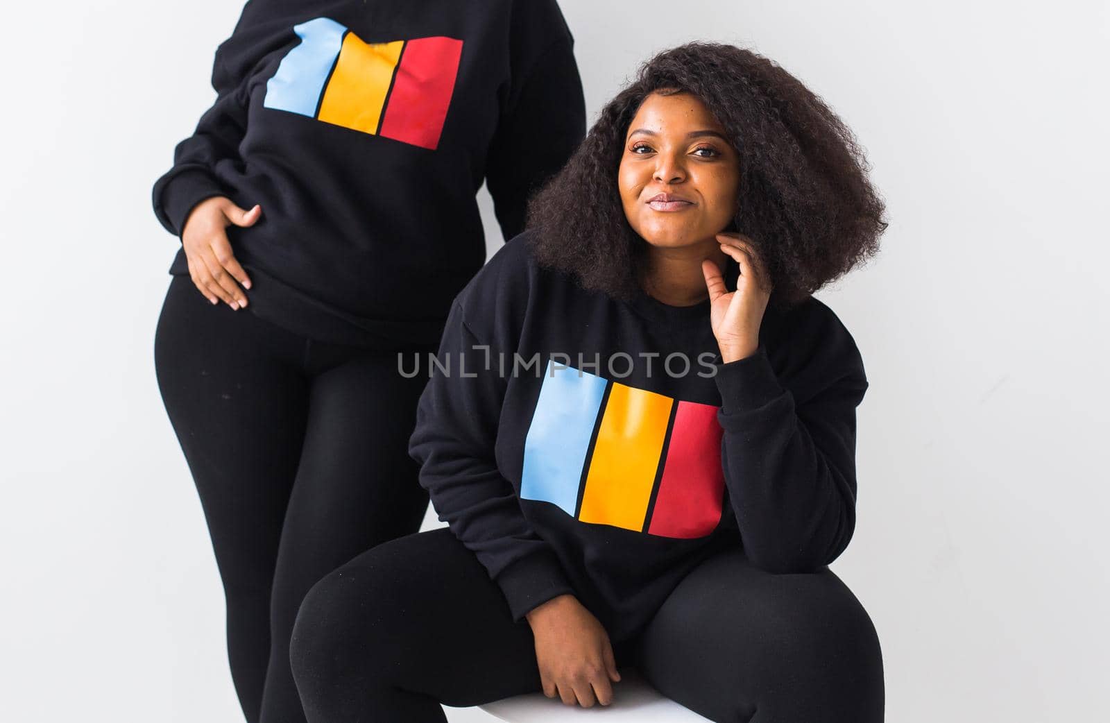 Happy African American women have relationships, toothy smile, happy to meet with friends, dressed casually on white background. Emotions and friendship concept