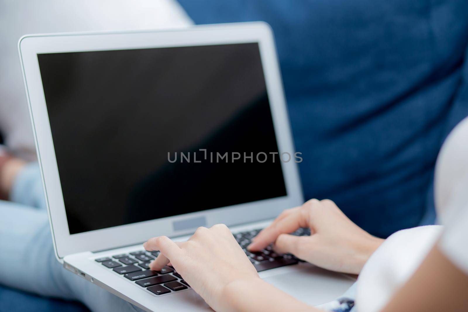 Young asian woman work from home with laptop computer blank screen mockup, freelance girl using notebook with empty, girl typing keyboard and relax with multimedia, business and communication concept. by nnudoo