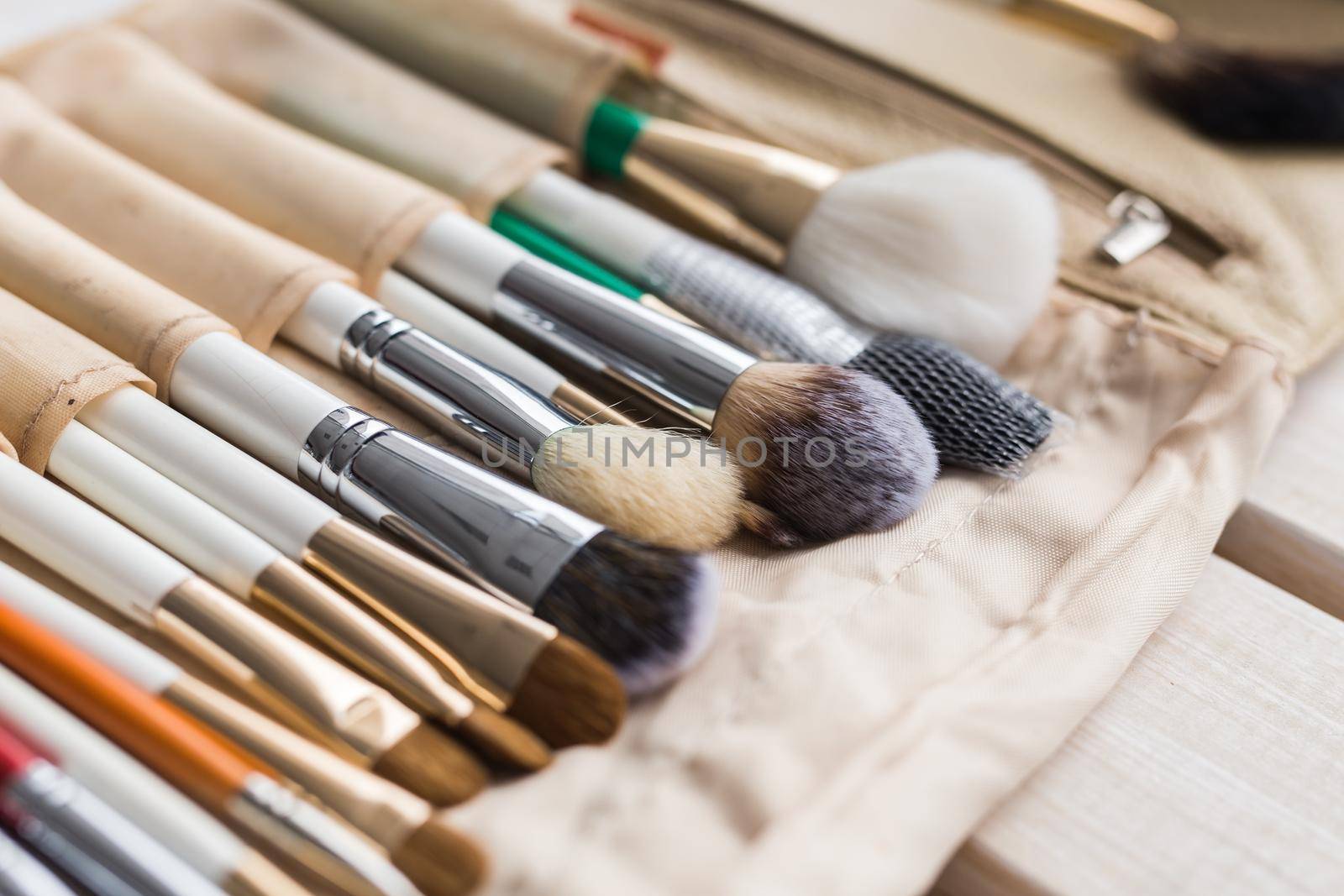 beauty and cosmetics concept - Set of make-up brushes in a light case.