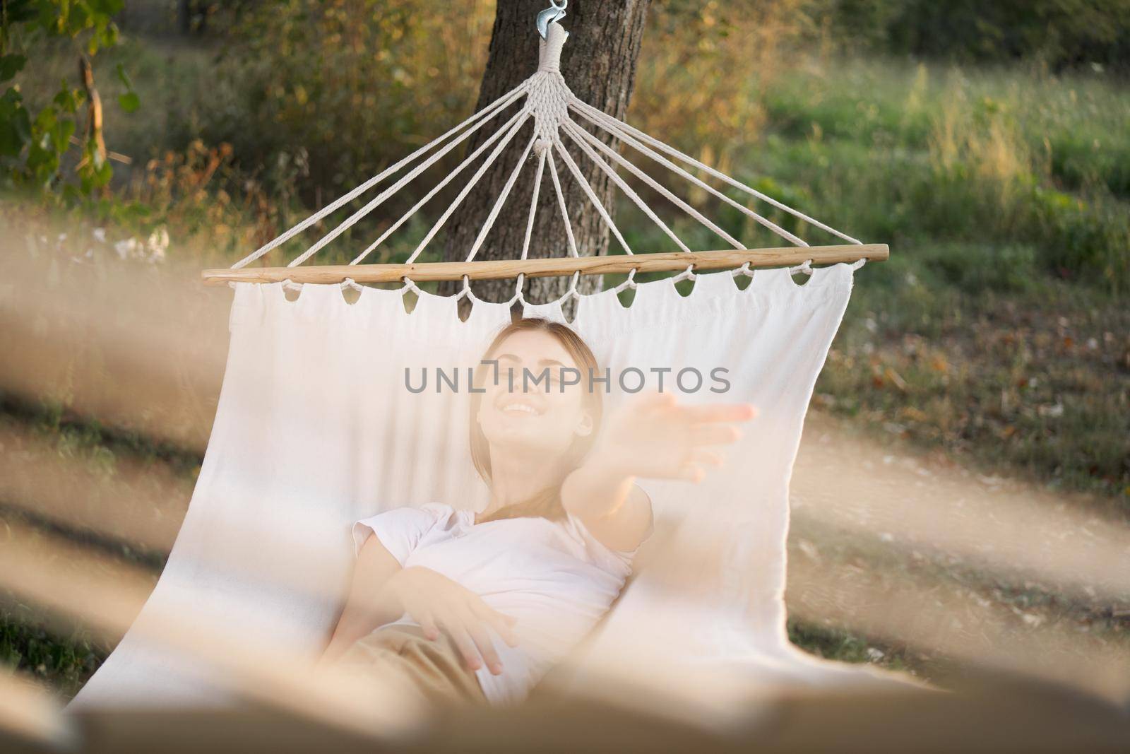 woman relaxing in nature in a hammock garden fresh air. High quality photo