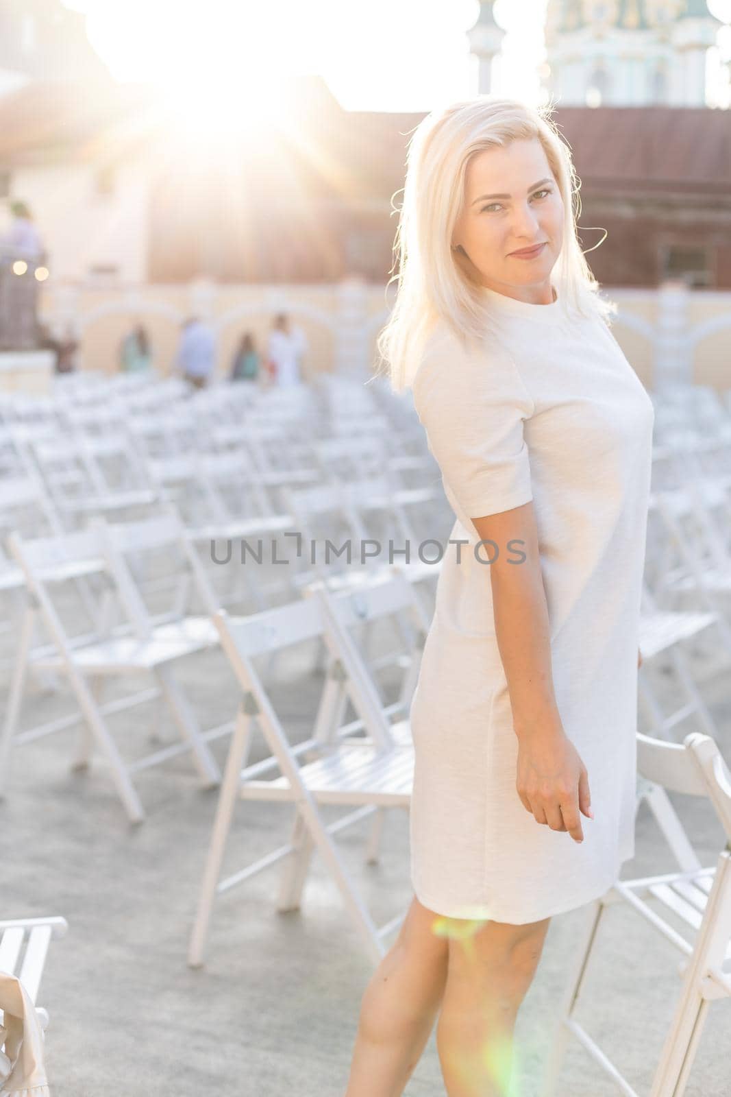 an empty concert hall, woman near empty chairs at concert