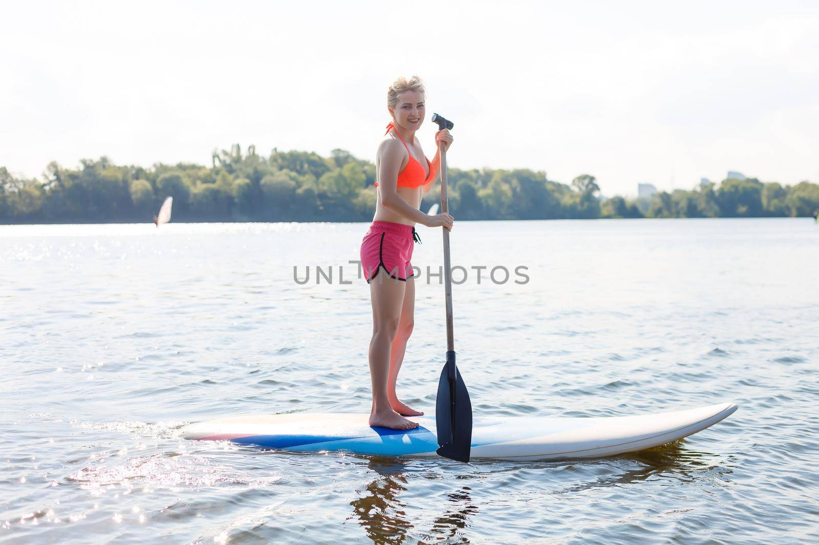 A beautiful woman practicing paddle on a beautiful sunny day