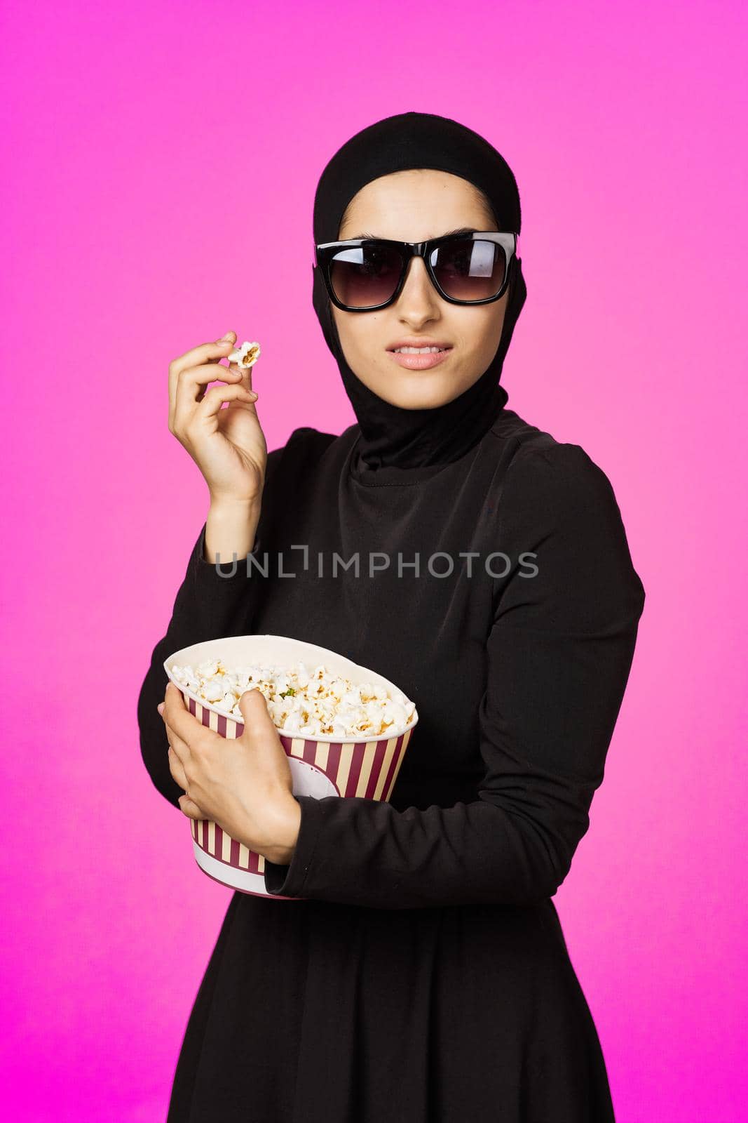 cheerful woman fun popcorn entertainment fashion purple background by Vichizh