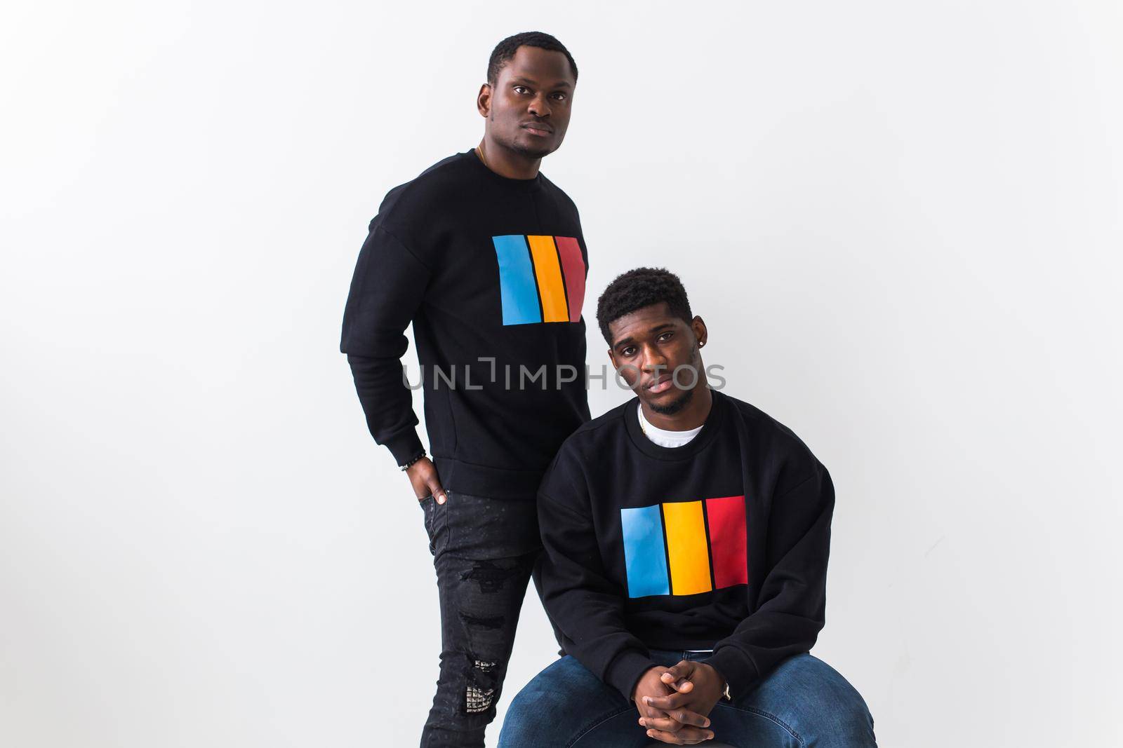 Street fashion and friendship concept - Two african american young men in black stylish sweatshirts. by Satura86