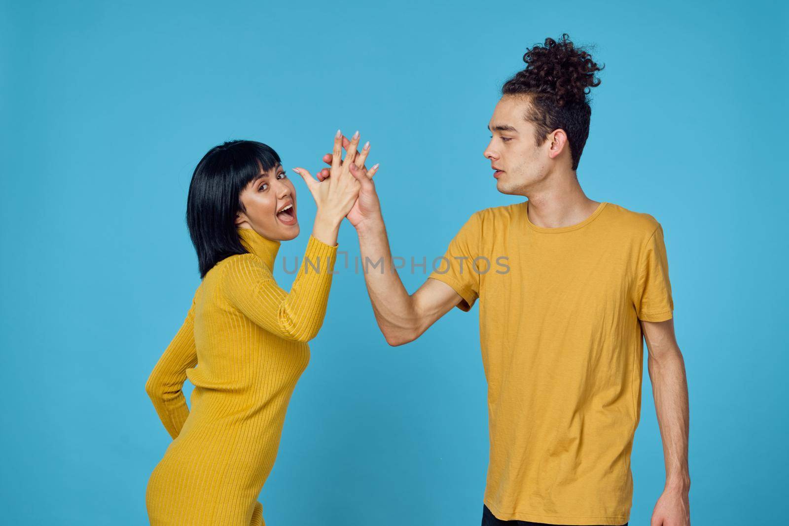 kinky guy and girl together friendship fun blue background. High quality photo