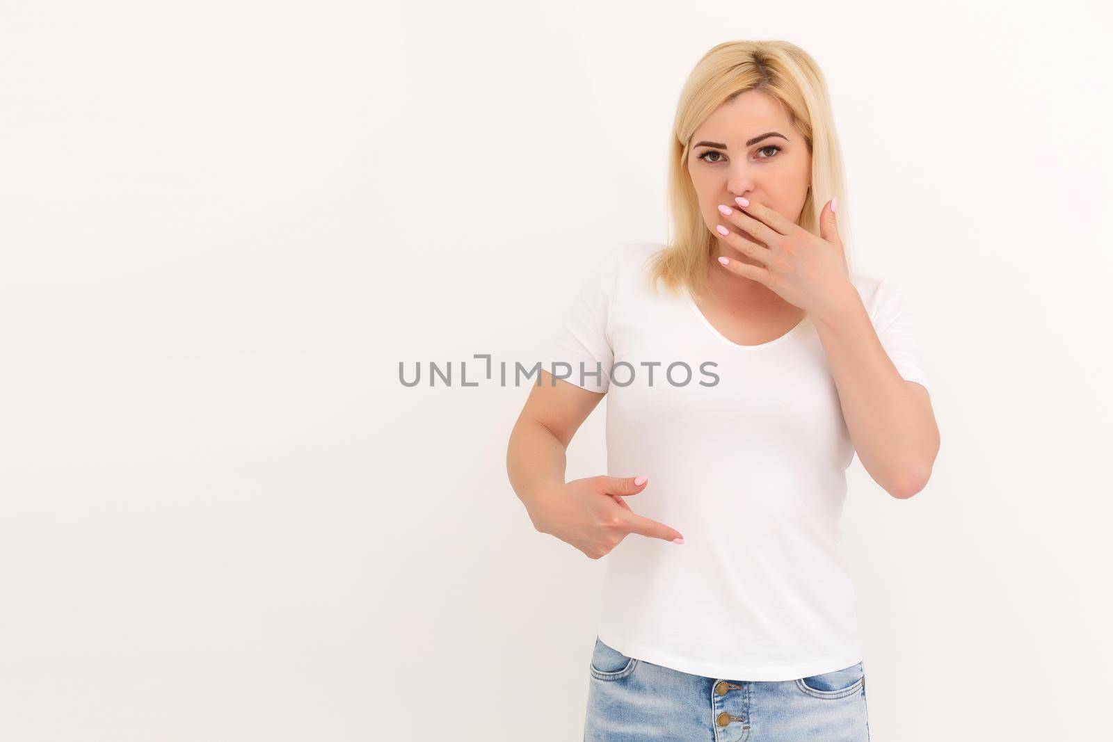 woman shows a spot on her white t-shirt