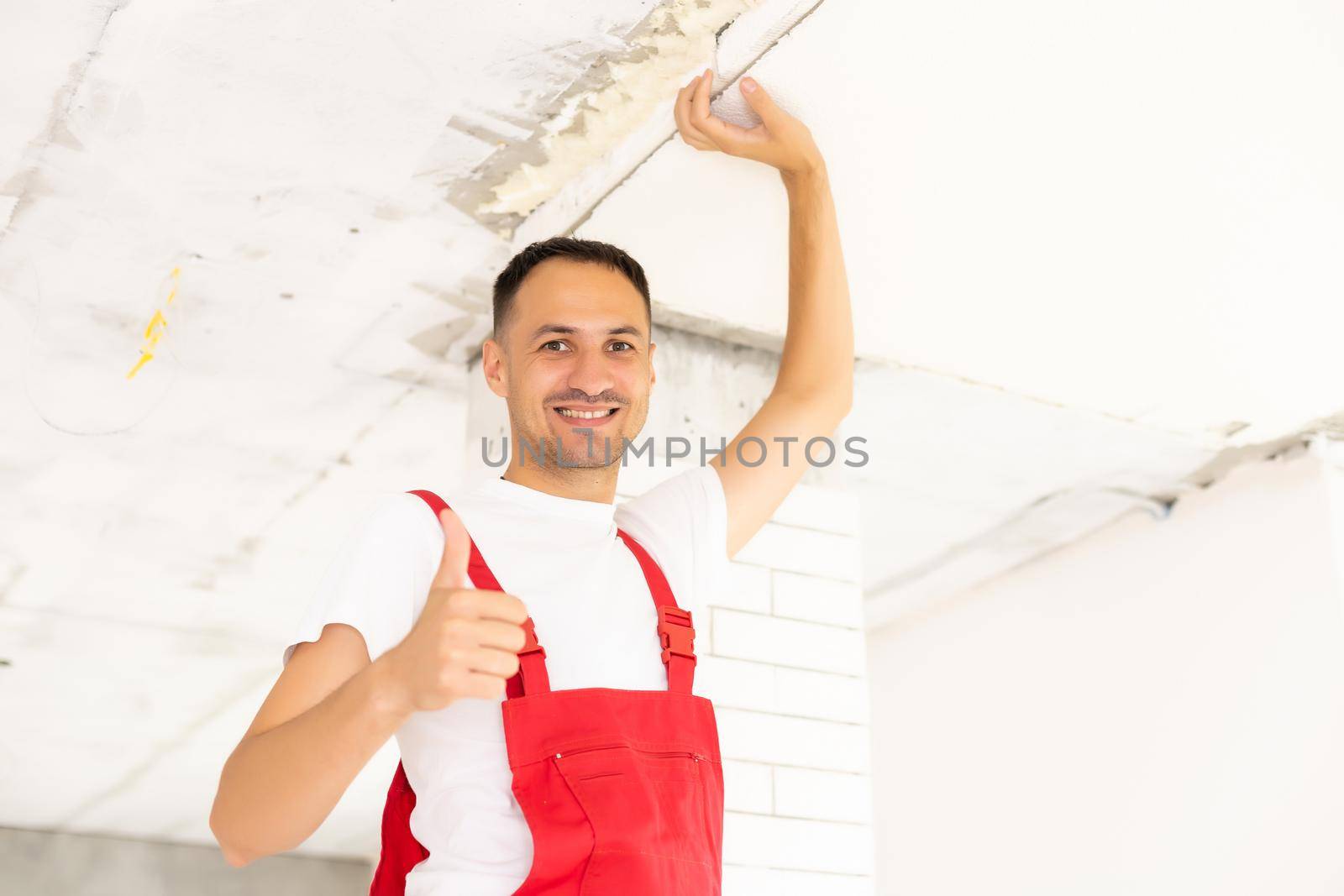 Young man fixing ceiling insulated. Renovation, construction