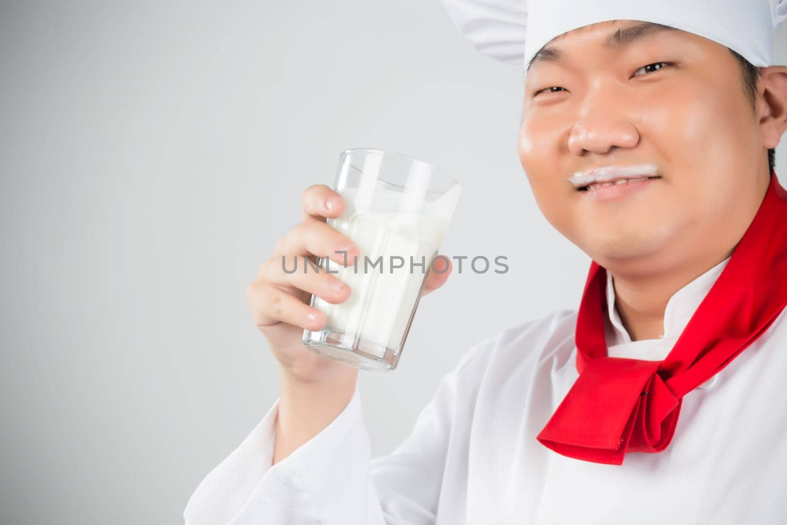 chef holding glass cup and drink yogurt or milk nice photo