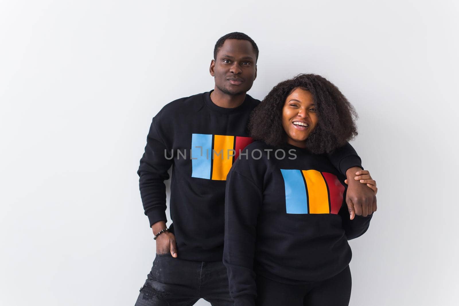 Happy African American woman and man have relationships, toothy smile, happy to meet with friends, dressed casually on white background. Emotions and friendship concept. by Satura86