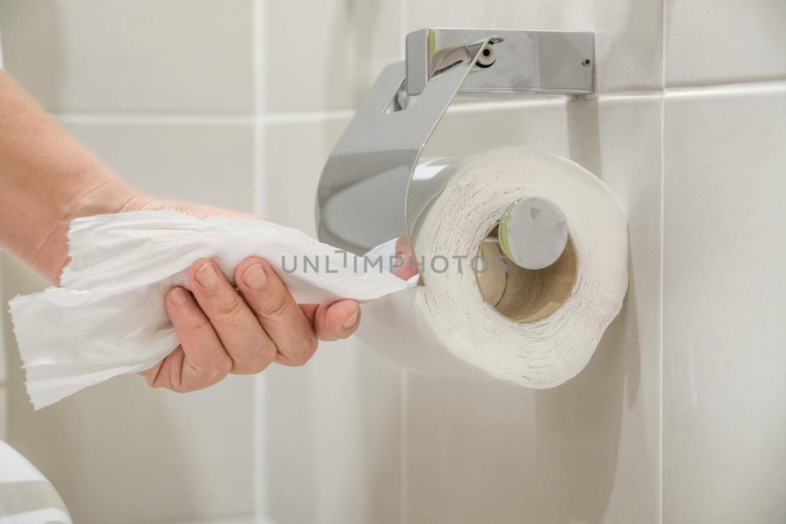 Woman using toilet paper.