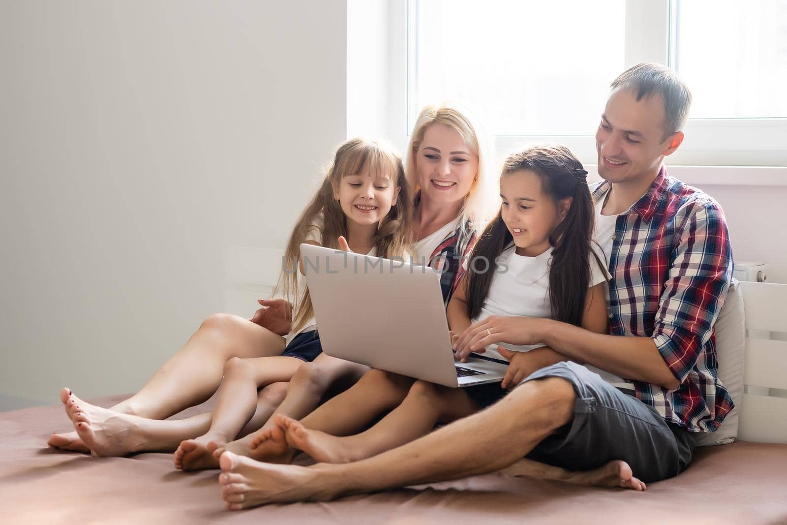 Animated family buying online lying down on bed at home