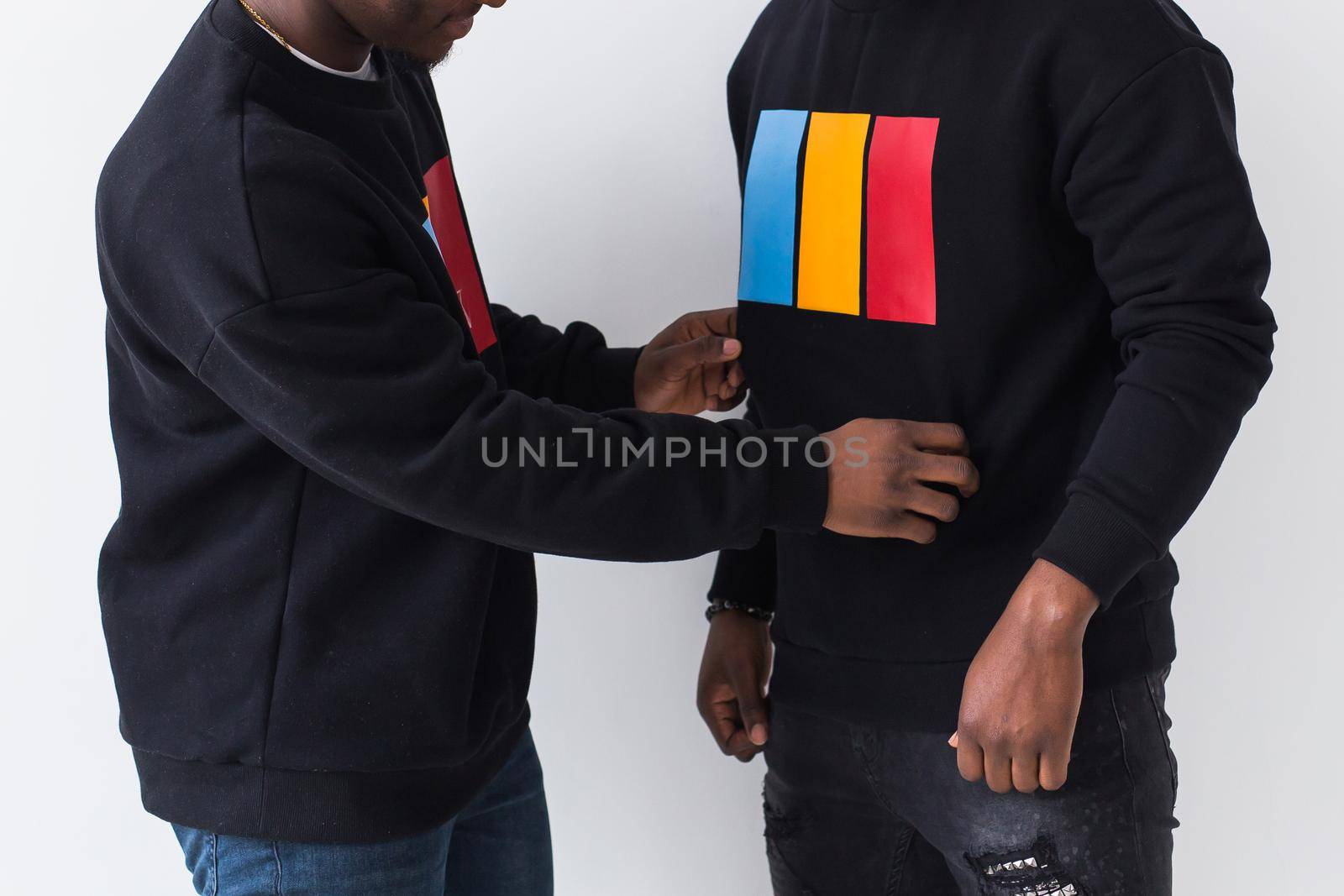 Street fashion and friendship concept - Two happy african american young men in black stylish sweatshirts, close-up. by Satura86