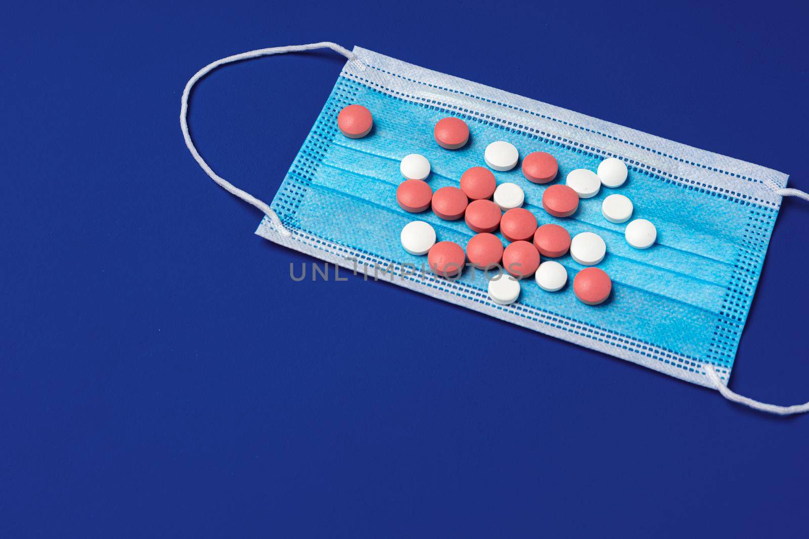 Vitamins and face protective mask close up. Coronavirus prevention concept
