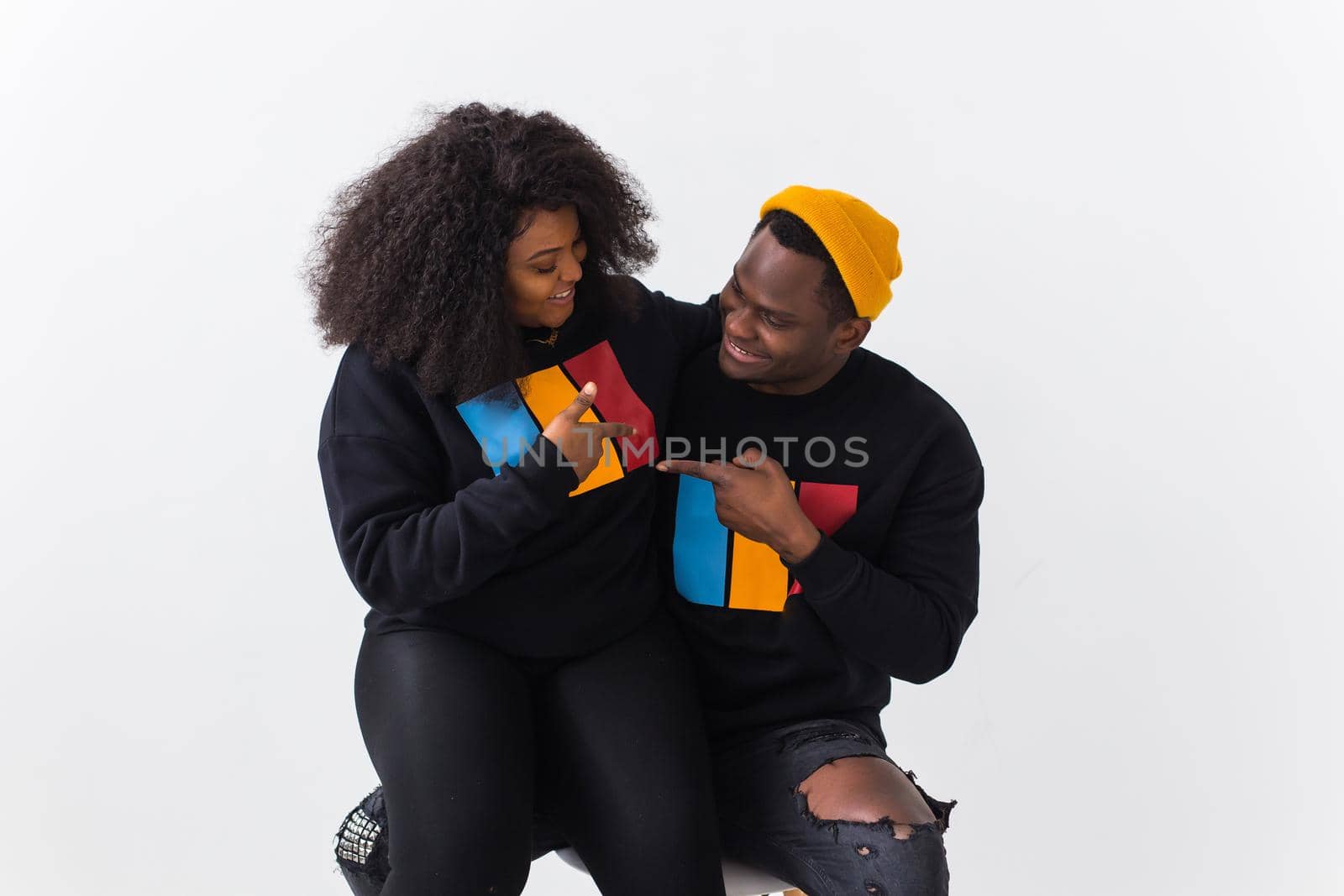 Happy African American woman and man have relationships, toothy smile, happy to meet with friends, dressed casually on white background. Emotions and friendship concept. by Satura86