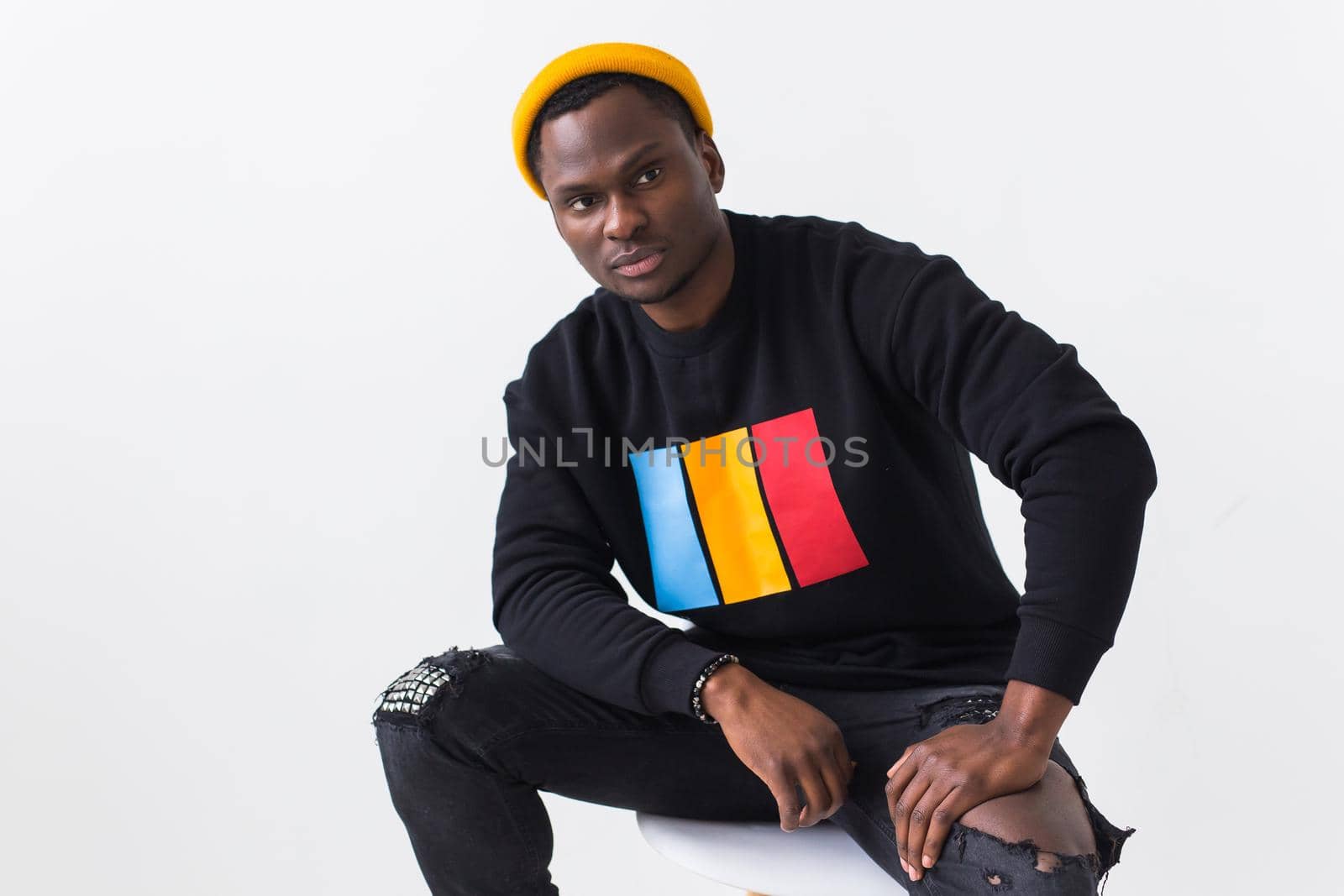 Young handsome african american man with an afro hairstyle. Portrait on white background. Guy looking at camera