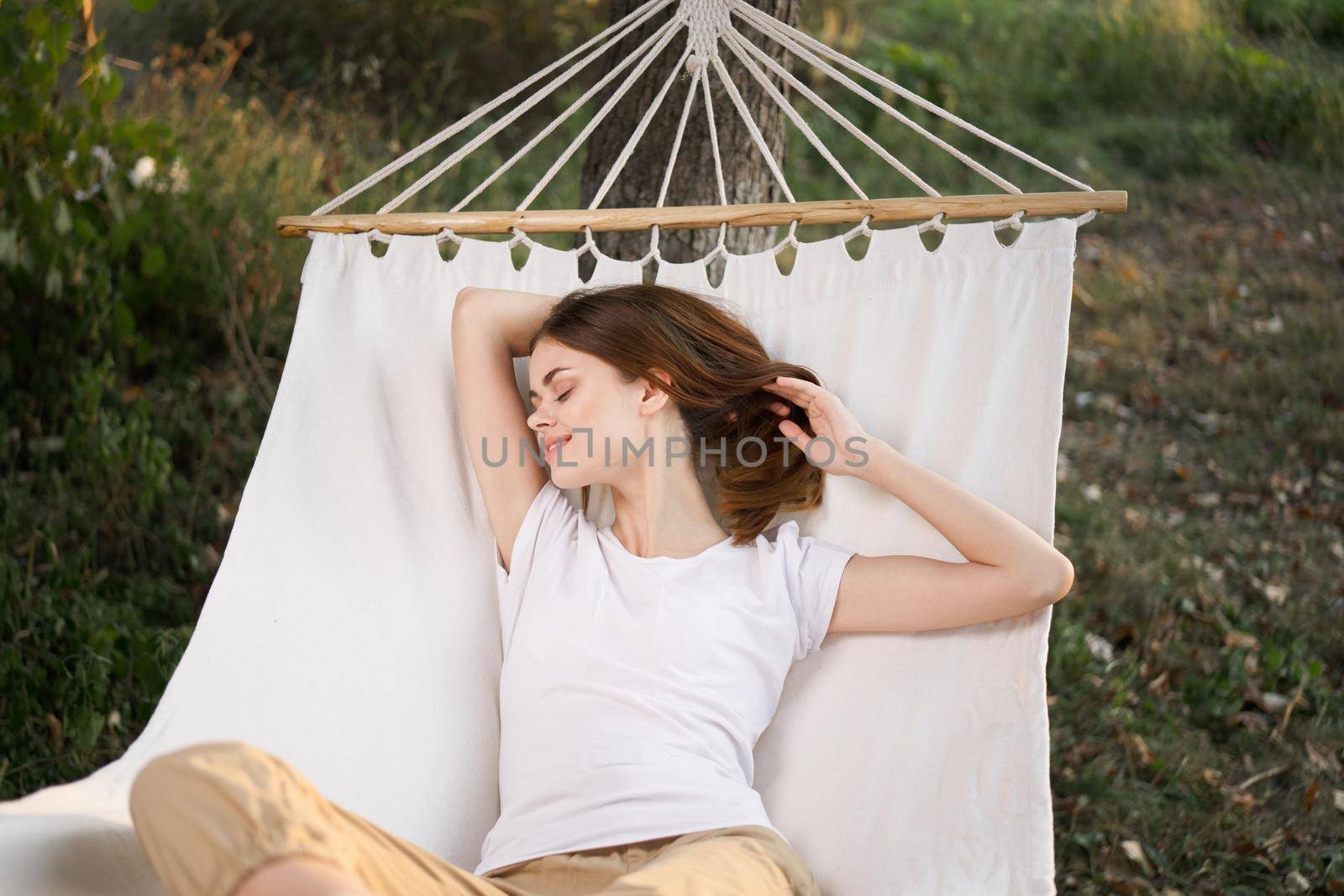 woman relaxing in nature in a hammock garden fresh air by Vichizh