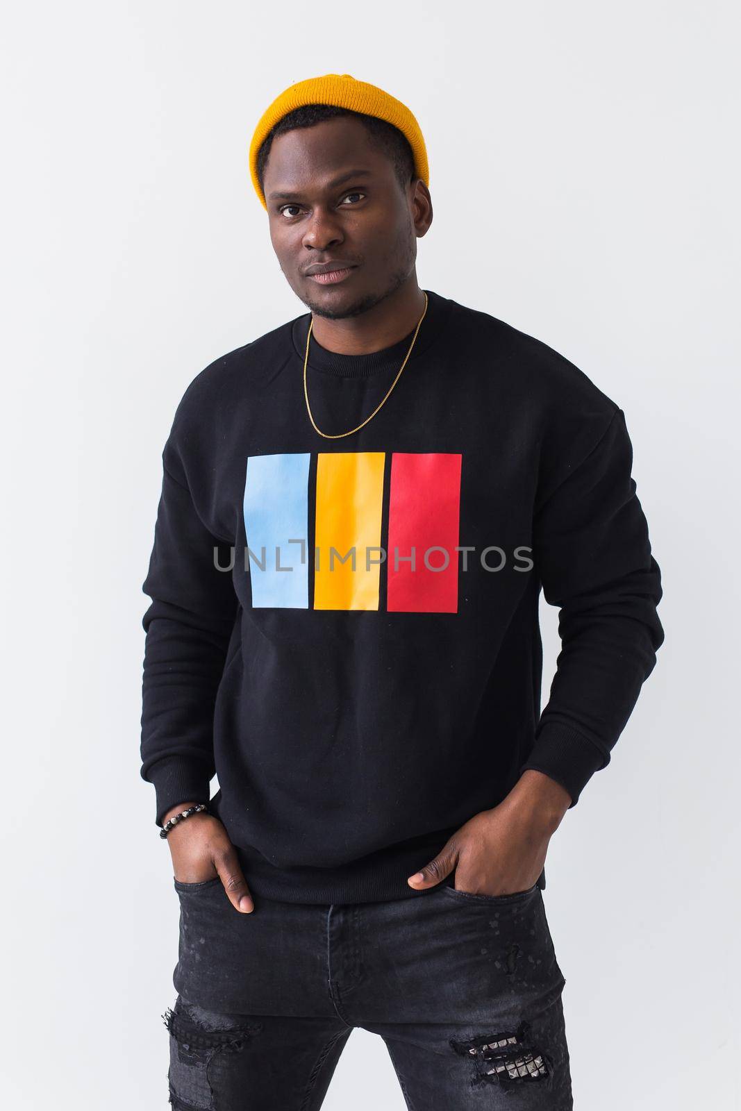 Youth street fashion concept - Portrait of confident sexy black man in stylish sweatshirt on white background. by Satura86