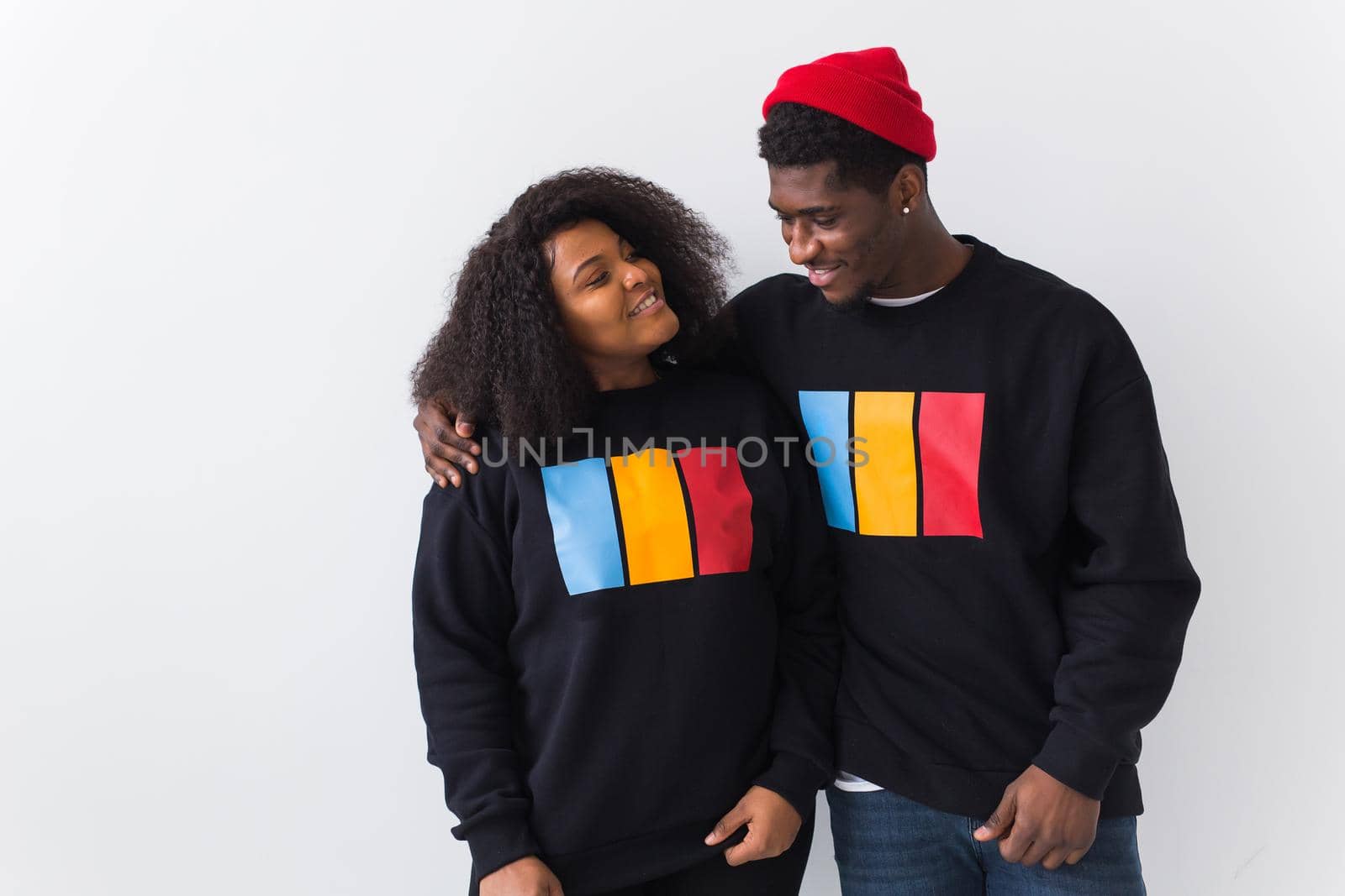 Happy African American woman and man have relationships, toothy smile, happy to meet with friends, dressed casually on white background. Emotions and friendship