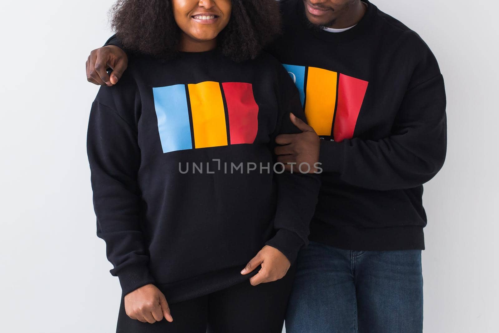 Close-up of African American woman and man have relationships, toothy smile, happy to meet with friends, dressed casually on white background. Emotions and friendship concept. by Satura86