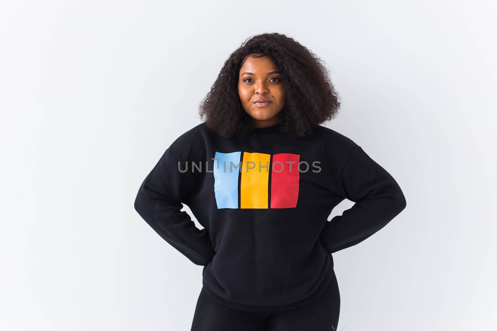 Young beautiful african american girl with an afro hairstyle. Portrait on white background. Girl looking at camera