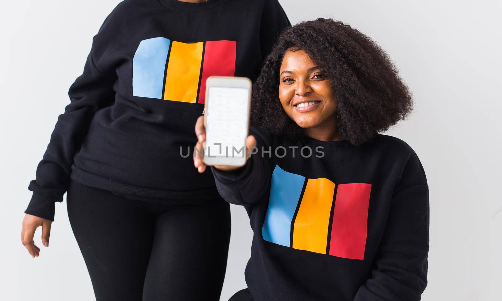 African american woman showing blank phone screen, mockup by Satura86