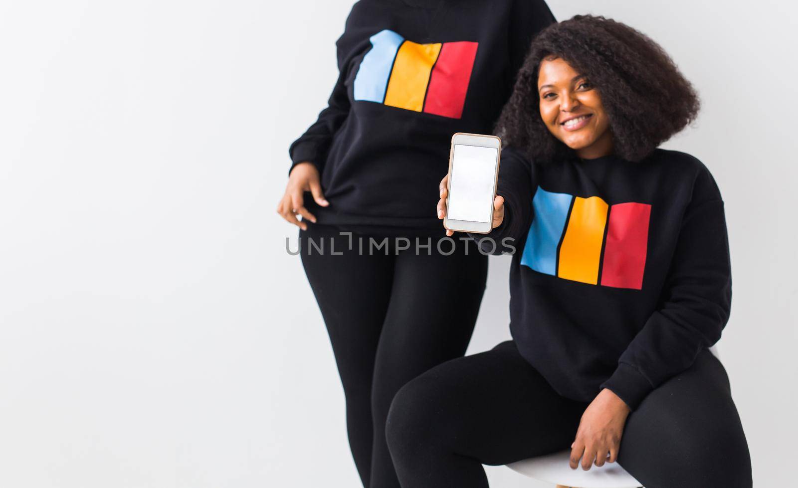 Modern Technology Concept. African american woman showing blank phone screen, mockup, selective focus