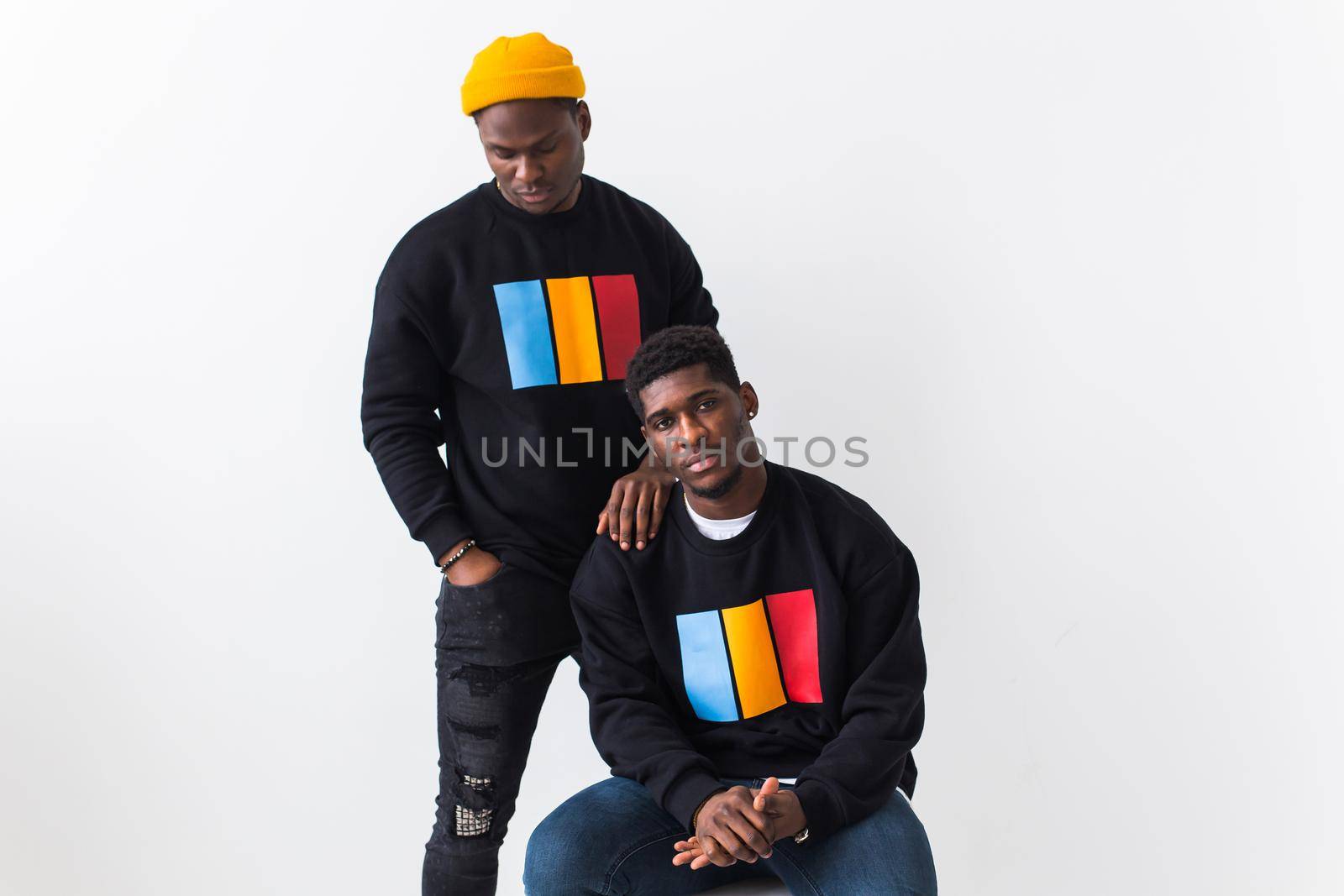 Street fashion and friendship concept - Two happy african american young men in black stylish sweatshirts