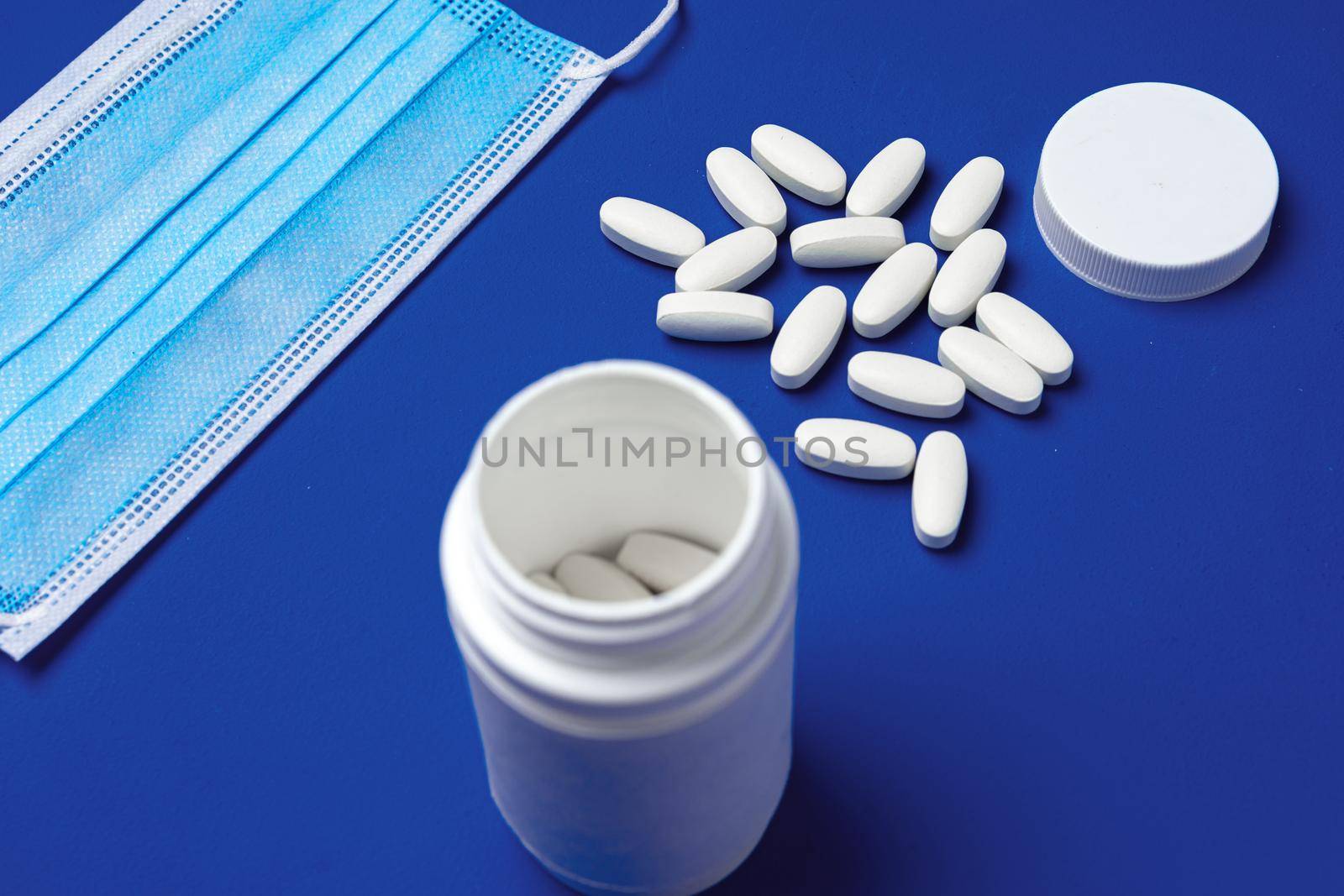 Vitamins and face protective mask close up. Coronavirus prevention concept