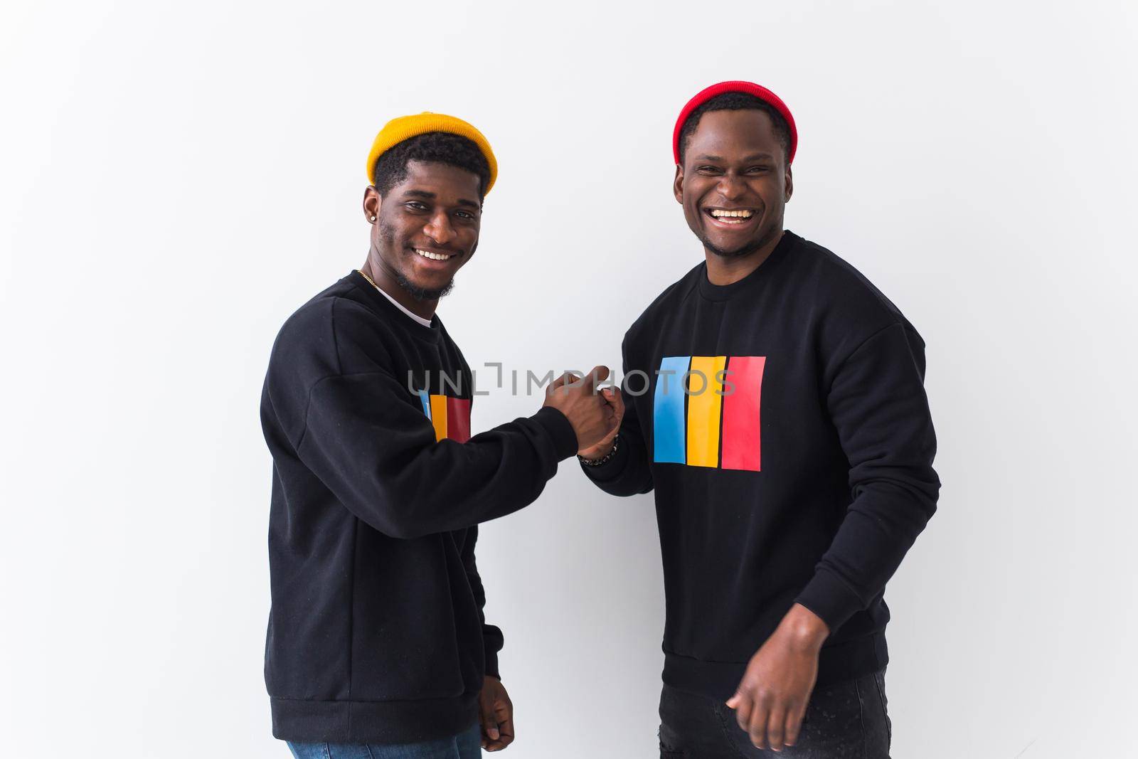 Street fashion and friendship concept - Two happy african american young men in black stylish sweatshirts. by Satura86
