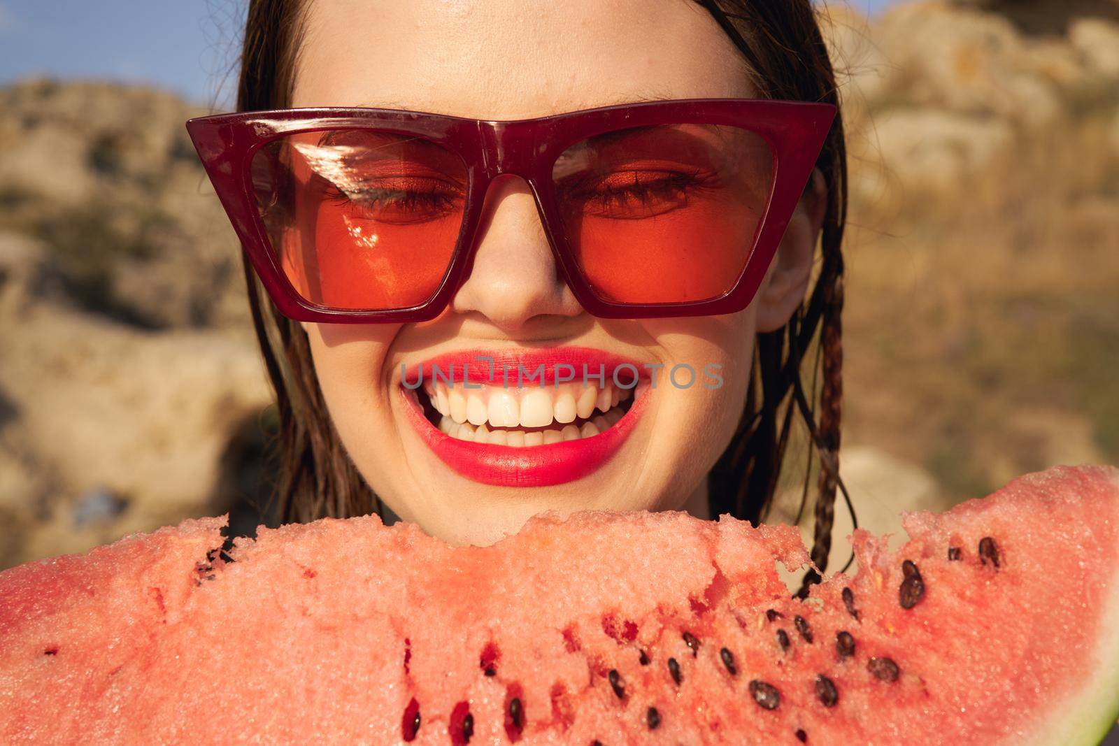 Cheerful woman eating watermelon nature summer vacation. High quality photo