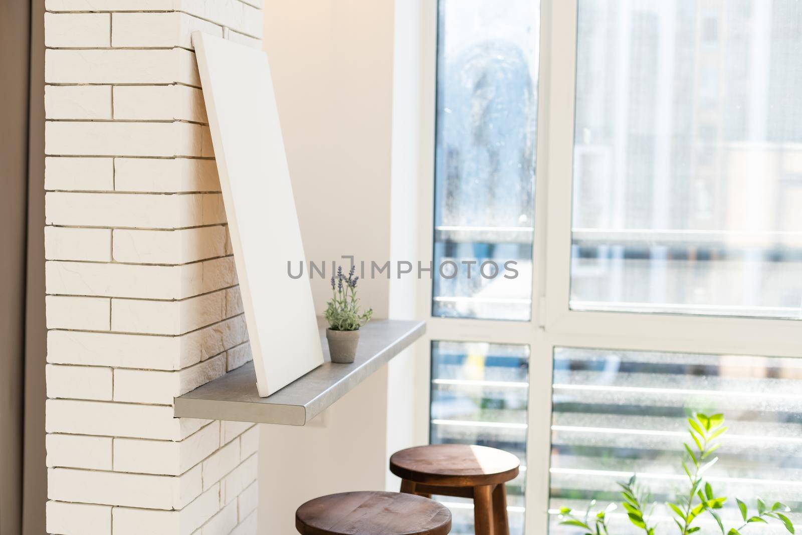 Blank white poster banner standing in the apartment. Mock up template for present business concept.