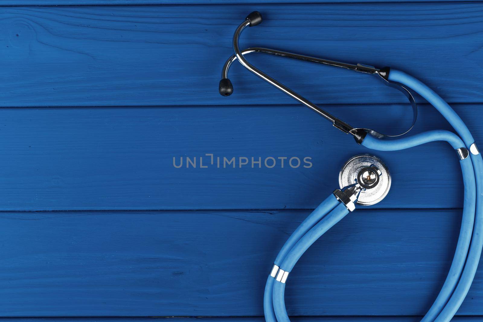 Medical stethoscope on classic blue background top view. High quality photo