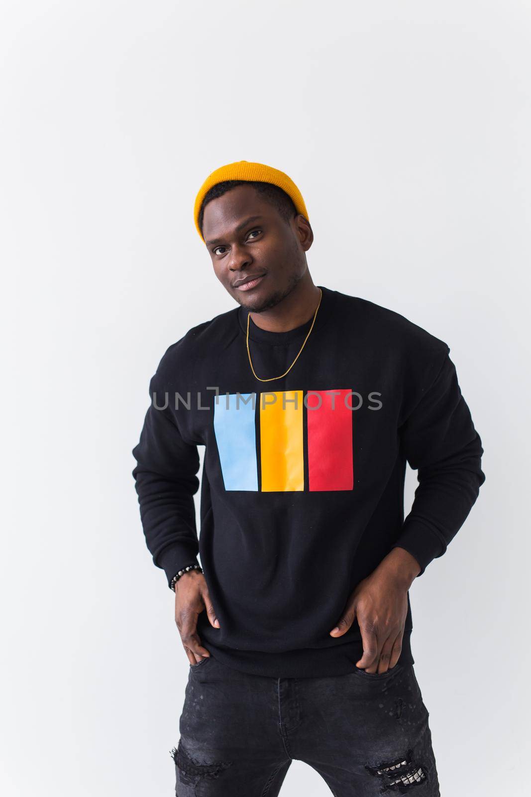 Youth street fashion concept - Portrait of confident sexy black man in stylish sweatshirt on white background. by Satura86