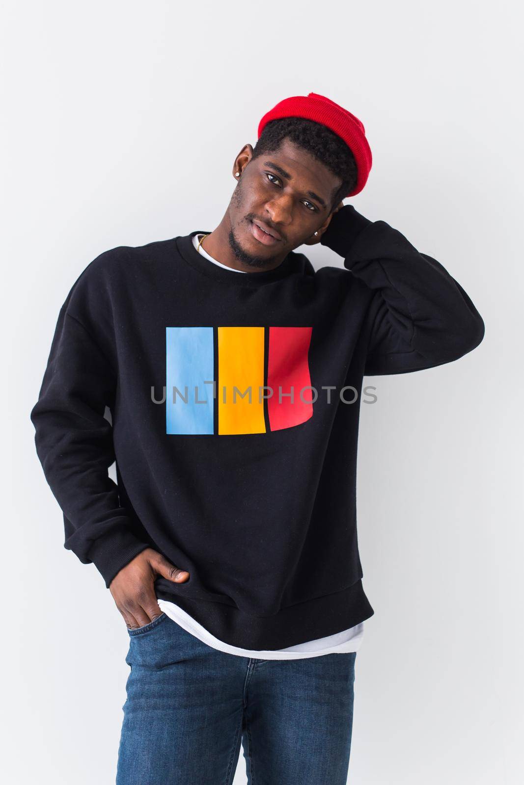 Handsome African American man posing in black sweatshirt on a white background. Youth street fashion photo with afro hairstyle. by Satura86