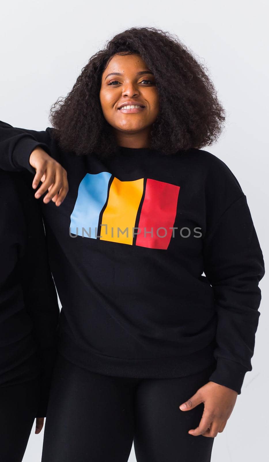 Young beautiful african american girl with an afro hairstyle. Portrait on white background. Girl looking at camera